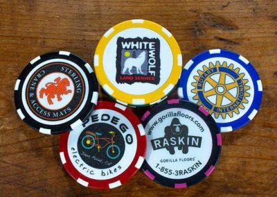 5 custom poker chips for different industries showing logos on bright colored chip borders