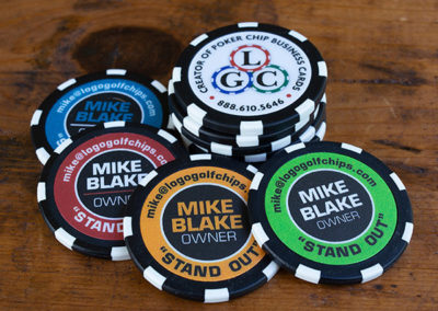 a stack of brightly colored Mike Blake, owner of poker chip universes personal custom poker chip business cards