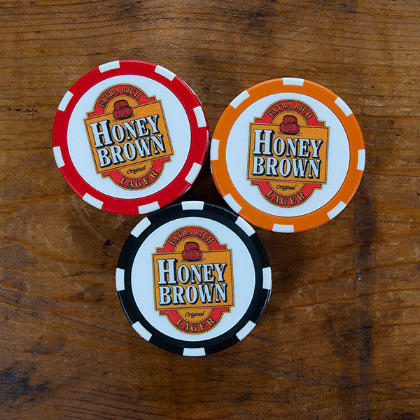 Honey Brown Extra Rich Lager logo on red, orange, and black poker chips
