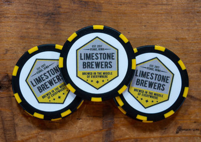 Black poker chip with yellow stripes featuring Limestone Brewers logo