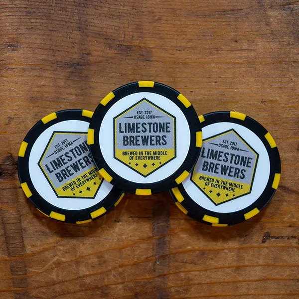 Black poker chip with yellow stripes featuring Limestone Brewers logo