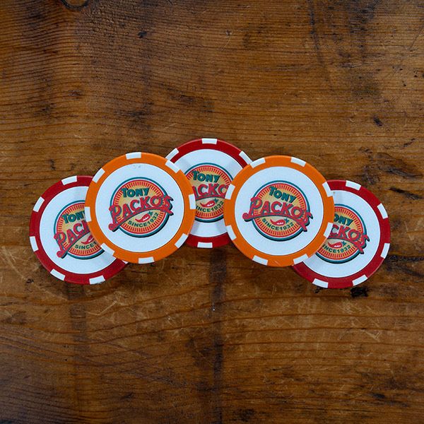 Tony Packos logo on five stacked orange and red custom poker chips