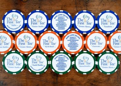 blue, orange, and green custom poker chips for The First Tee youth golf organization